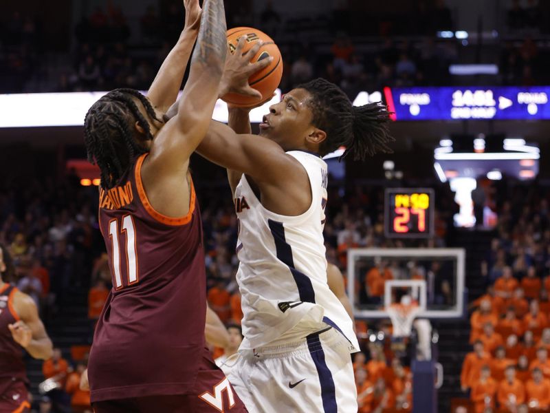 Feb 1, 2025; Charlottesville, Virginia, USA; Virginia Cavaliers guard Dai Dai Ames (7) controls the ball as Virginia Tech Hokies guard Ben Hammond (11) defends during the second half at John Paul Jones Arena. Mandatory Credit: Amber Searls-Imagn Images