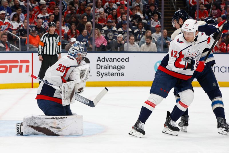 Apr 14, 2026; Columbus, Ohio, USA; Washington Capitals goalie Clay Stevenson (33) makes a glove save against the Columbus Blue Jackets during the second period at Nationwide Arena. Mandatory Credit: Russell LaBounty-Imagn Images