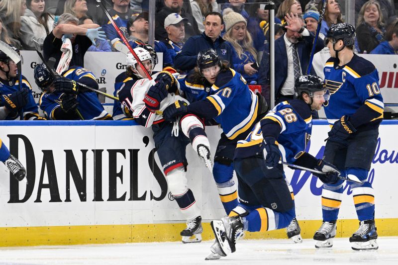 Jan 30, 2024; St. Louis, Missouri, USA; St. Louis Blues center Oskar Sundqvist (70) finishes his check on Columbus Blue Jackets center Kent Johnson (91) during the third period at Enterprise Center. Mandatory Credit: Jeff Le-USA TODAY Sports