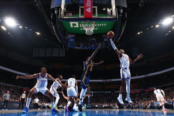 OKLAHOMA CITY, OK - DECEMBER 8: Shai Gilgeous-Alexander #2 of the Oklahoma City Thunder drives to the basket during the game against the Golden State Warriors on December 8, 2023 at Paycom Arena in Oklahoma City, Oklahoma. NOTE TO USER: User expressly acknowledges and agrees that, by downloading and or using this photograph, User is consenting to the terms and conditions of the Getty Images License Agreement. Mandatory Copyright Notice: Copyright 2023 NBAE (Photo by Zach Beeker/NBAE via Getty Images)