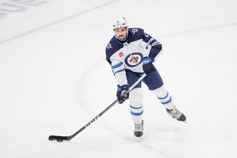 Feb 23, 2024; Chicago, Illinois, USA; Winnipeg Jets defenseman Dylan DeMelo (2) looks to pass the puck against the Chicago Blackhawks during the first period at United Center. Mandatory Credit: Kamil Krzaczynski-USA TODAY Sports