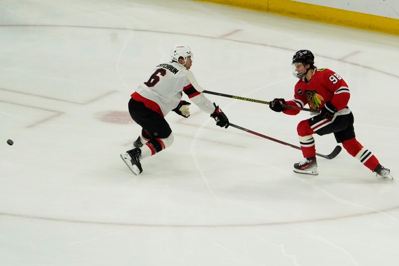 Feb 17, 2024; Chicago, Illinois, USA; Chicago Blackhawks center Connor Bedard (98) shoots the puck on Ottawa Senators defenseman Jakob Chychrun (6) during the first period at United Center. Mandatory Credit: David Banks-USA TODAY Sports