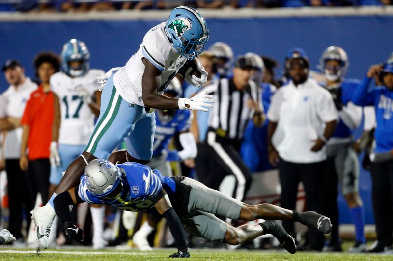 Oct 13, 2023; Memphis, Tennessee, USA; Tulane Green Wave tight end Chris Carter (11) is knocked off his feet by Memphis Tigers defensive back Cameron Smith (29) during the second half at Simmons Bank Liberty Stadium. Mandatory Credit: Petre Thomas-USA TODAY Sports