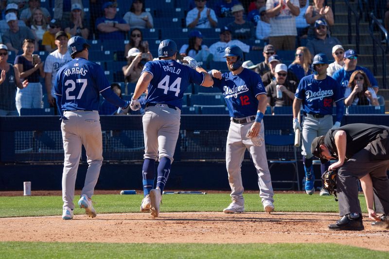 Mar 2, 2024; Phoenix, Arizona, USA; Los Angeles Dodgers infielders Kevin Padlo (44) celebrate with Miguel Vargas (27) and Chris Owens (12) after Padlo hit a home run in the seventh during a spring training game against the Milwaukee Brewers at American Family Fields of Phoenix. Mandatory Credit: Allan Henry-USA TODAY Sports