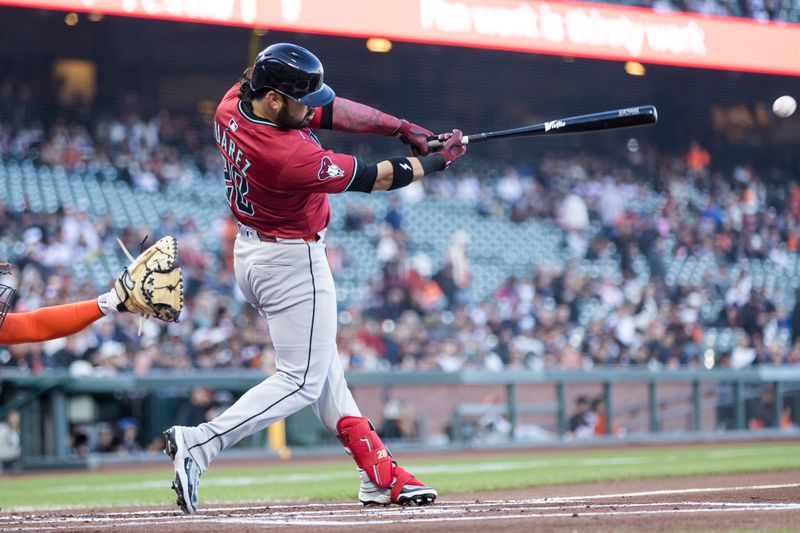 May 13, 2025; San Francisco, California, USA; Arizona Diamondbacks third baseman Eugenio Suarez (28) hits an RBI double against the San Francisco Giants during the first inning at Oracle Park. Mandatory Credit: John Hefti-Imagn Images