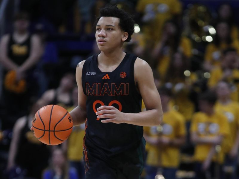 Feb 15, 2025; Pittsburgh, Pennsylvania, USA; Miami (Fl) Hurricanes guard Divine Ugochukwu (99) dribbles up court against the Pittsburgh Panthers during the first half at the Petersen Events Center. Mandatory Credit: Charles LeClaire-Imagn Images