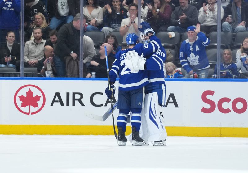 Jan 10, 2026; Toronto, Ontario, CAN; Toronto Maple Leafs goaltender Joseph Woll (60) celebrates the win with defenseman Troy Stecher (28) against the Vancouver Canucks at the end of the third period at Scotiabank Arena. Mandatory Credit: Nick Turchiaro-Imagn Images