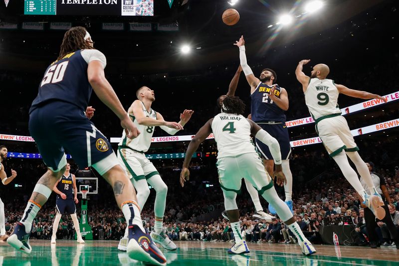 BOSTON, MA - JANUARY 19: Jamal Murray #27 of the Denver Nuggets shoots over Jrue Holiday #4 of the Boston Celtics and Kristaps Porzingis #8 during the second half at TD Garden on January 19, 2024 in Boston, Massachusetts. NOTE TO USER: User expressly acknowledges and agrees that, by downloading and/or using this Photograph, user is consenting to the terms and conditions of the Getty Images License Agreement. (Photo By Winslow Townson/Getty Images)