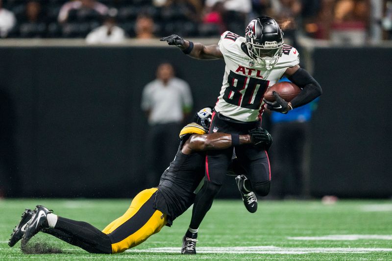 Atlanta Falcons wide receiver Josh Ali (80) is wrapped up by Pittsburgh Steelers safety Jalen Elliott (16) during the second half of an NFL preseason football game, Thursday, Aug. 24, 2023, in Atlanta. The Pittsburgh Steelers won 24-0. (AP Photo/Danny Karnik)