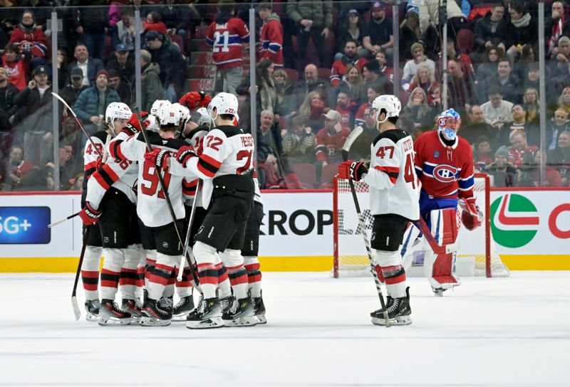 Jan 25, 2025; Montreal, Quebec, CAN; New Jersey Devils defenseman Luke Hughes (43) celebrates with teammates after scoring the winning goal against Montreal Canadiens goalie Jakub Dobes (75) during the overtime period at the Bell Centre. Mandatory Credit: Eric Bolte-Imagn Images