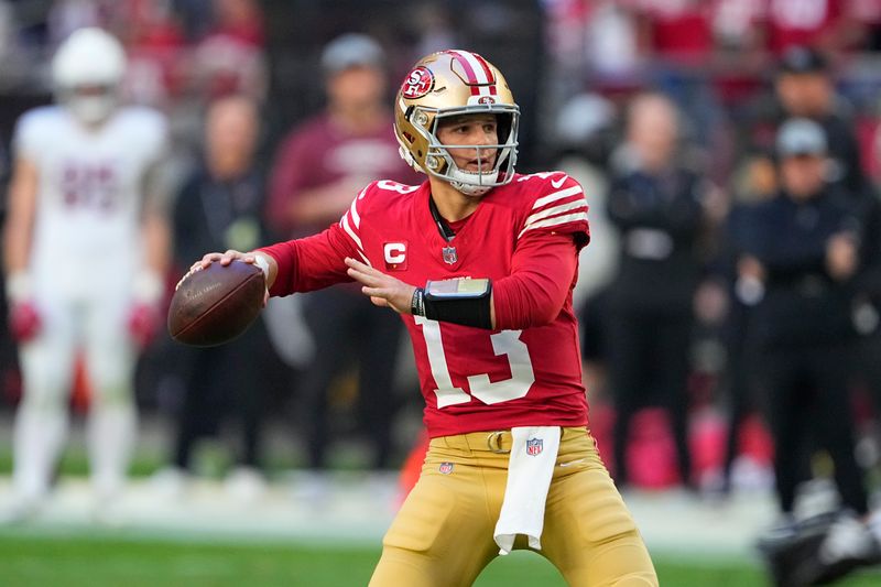 San Francisco 49ers quarterback Brock Purdy passes against the Arizona Cardinals during the first half of an NFL football game Sunday, Dec. 17, 2023, in Glendale, Ariz. (AP Photo/Matt York)