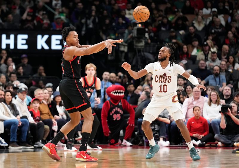 TORONTO, ON - FEBRUARY 10: Scottie Barnes #4 of the Toronto Raptors passes the ball off against Darius Garland #10 of the Cleveland Cavaliers during the first half of their basketball game at the Scotiabank Arena on February 10, 2024 in Toronto, Ontario, Canada. NOTE TO USER: User expressly acknowledges and agrees that, by downloading and/or using this Photograph, user is consenting to the terms and conditions of the Getty Images License Agreement. (Photo by Mark Blinch/Getty Images)