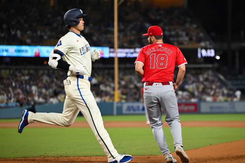 Jun 22, 2024; Los Angeles, California, USA; Los Angeles Dodgers designated hitter Shohei Ohtani (17) is forced out at first base against Los Angeles Angels first baseman Nolan Schanuel (18) during the eighth inning at Dodger Stadium. Mandatory Credit: Jonathan Hui-USA TODAY Sports