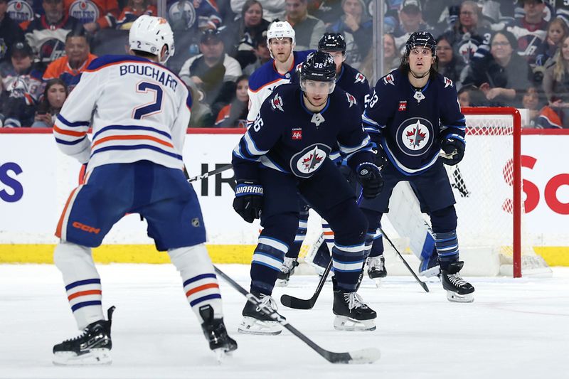Apr 13, 2025; Winnipeg, Manitoba, CAN; Winnipeg Jets center Morgan Barron (36) blocks a shot from Edmonton Oilers defenseman Evan Bouchard (2) in the second period at Canada Life Centre. Mandatory Credit: James Carey Lauder-Imagn Images