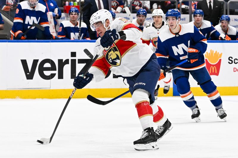 Jan 27, 2024; Elmont, New York, USA; Florida Panthers center Evan Rodrigues (17) attempts a shot against the New York Islanders during the third period at UBS Arena. Mandatory Credit: Dennis Schneidler-USA TODAY Sports