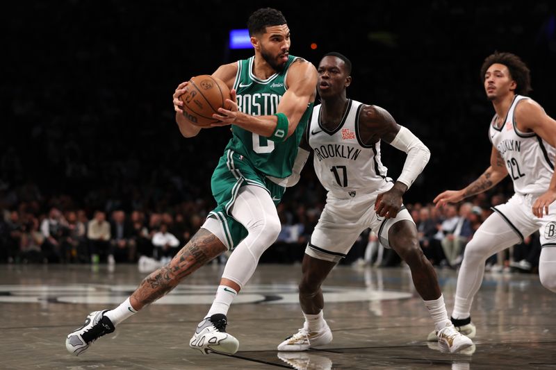 NEW YORK, NEW YORK - NOVEMBER 13: Jayson Tatum #0 of the Boston Celtics drives to the basket against Dennis Schroder #17 of the Brooklyn Nets during the third quarter at the Barclays Center on November 13, 2024 in the Brooklyn borough of New York City. NOTE TO USER: User expressly acknowledges and agrees that, by downloading and or using this photograph, User is consenting to the terms and conditions of the Getty Images License Agreement.  (Photo by Sarah Stier/Getty Images)