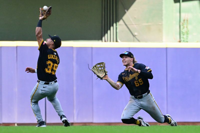 Jul 11, 2024; Milwaukee, Wisconsin, USA;  Pittsburgh Pirates second baseman Nick Gonzales (39) catches a popup hit by Milwaukee Brewers shortstop Willy Adames (not pictured) as center fielder Jack Suwinski (65) tries to avoid a collision in the seventh inning at American Family Field. Mandatory Credit: Benny Sieu-USA TODAY Sports