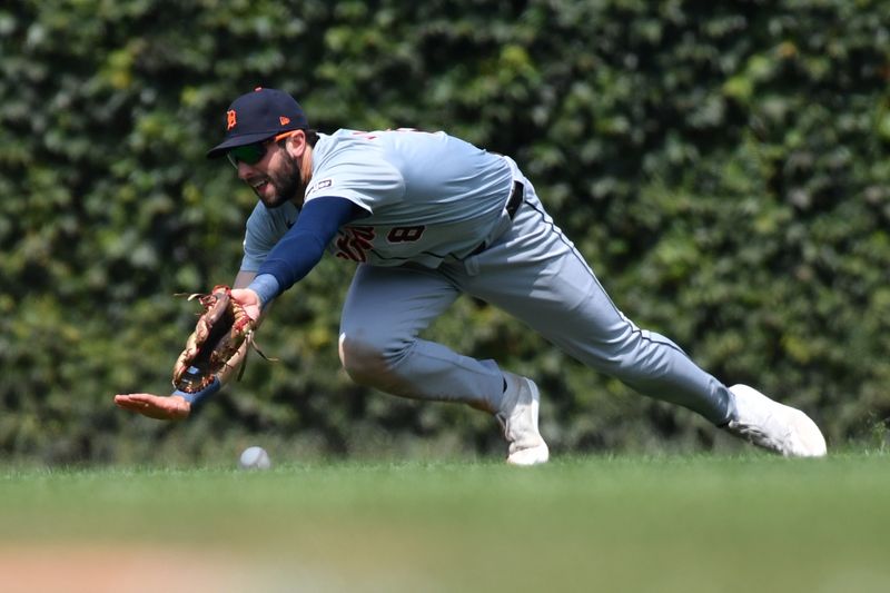 Aug 22, 2024; Chicago, Illinois, USA; Detroit Tigers center fielder Matt Vierling (8) attempts to catch a single hit by Chicago Cubs shortstop Dansby Swanson (not pictured) during the second inning at Wrigley Field. Mandatory Credit: Patrick Gorski-USA TODAY Sports