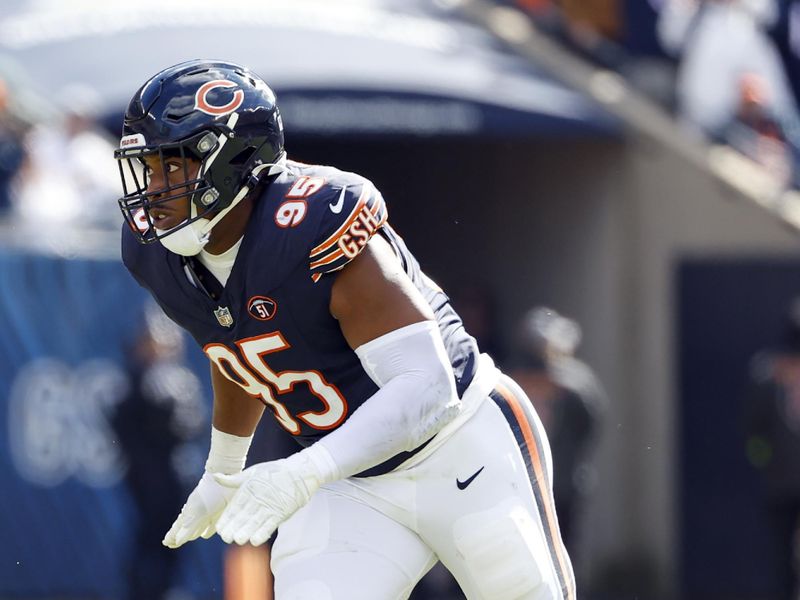 Chicago Bears defensive end DeMarcus Walker (95) runs on the field during the first half of an NFL football game against the Minnesota Vikings, Sunday, Oct. 15, 2023, in Chicago. (AP Photo/Kamil Krzaczynski)