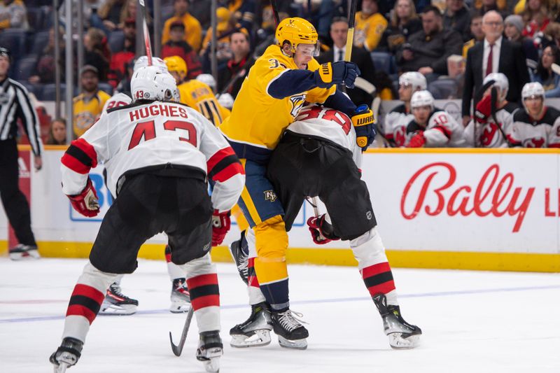 Feb 13, 2024; Nashville, Tennessee, USA;  Nashville Predators left wing Cole Smith (36) splits \d47\ and defenseman Kevin Bahl (88) chasing after a puck during the third period at Bridgestone Arena. Mandatory Credit: Steve Roberts-USA TODAY Sports