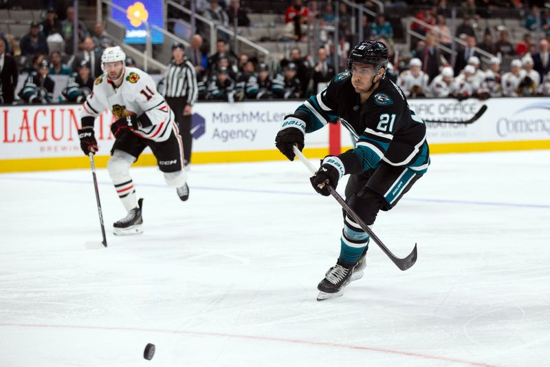 Oct 31, 2024; San Jose, California, USA; San Jose Sharks center Alexander Wennberg (21) passes the puck ahead to a teammate during the second period against the Chicago Blackhawks at SAP Center at San Jose. Mandatory Credit: D. Ross Cameron-Imagn Images