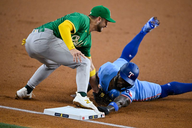 Sep 1, 2024; Arlington, Texas, USA; Oakland Athletics third baseman Max Schuemann (12) tags out Texas Rangers right fielder Adolis Garcia (53) on a steal attempt by Garcia during the first inning at Globe Life Field. Mandatory Credit: Jerome Miron-USA TODAY Sports