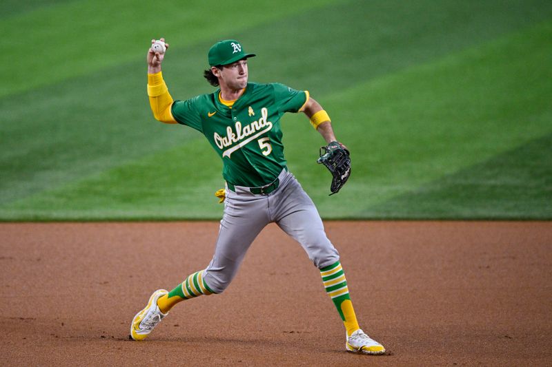 Sep 1, 2024; Arlington, Texas, USA; Oakland Athletics shortstop Jacob Wilson (5) throws to first base during the first inning against the Texas Rangers at Globe Life Field. Mandatory Credit: Jerome Miron-USA TODAY Sports