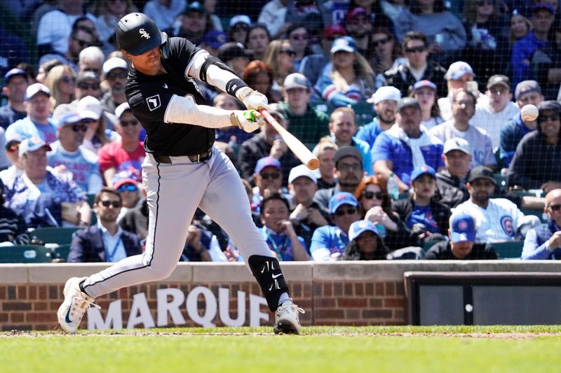 May 18, 2025; Chicago, Illinois, USA; Chicago White Sox third base Miguel Vargas (20) hits a single against the Chicago Cubs during the sixth inning at Wrigley Field. Mandatory Credit: David Banks-Imagn Images