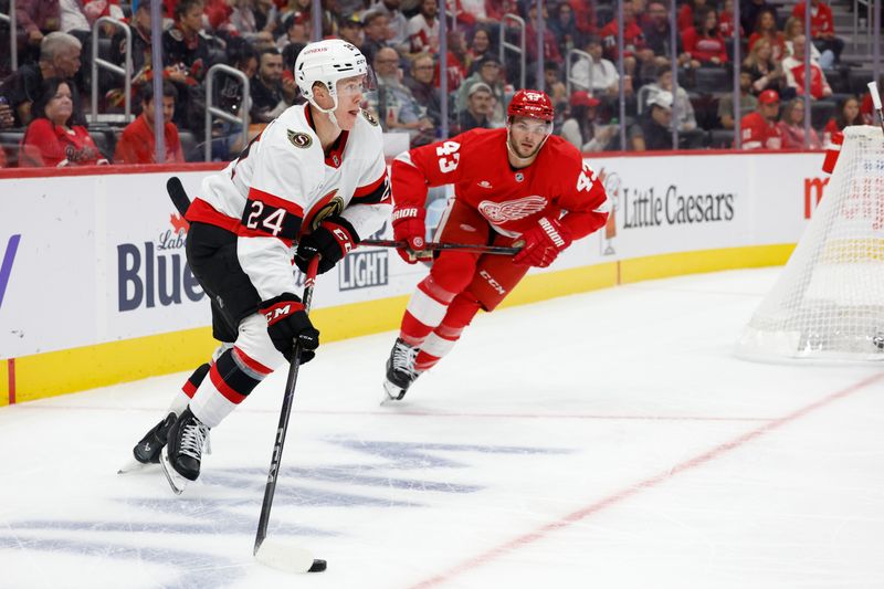 Oct 4, 2024; Detroit, Michigan, USA;  Ottawa Senators defenseman Jacob Bernard-Docker (24) skates with the puck while chased by Detroit Red Wings left wing Carter Mazur (43) in the second period at Little Caesars Arena. Mandatory Credit: Rick Osentoski-Imagn Images