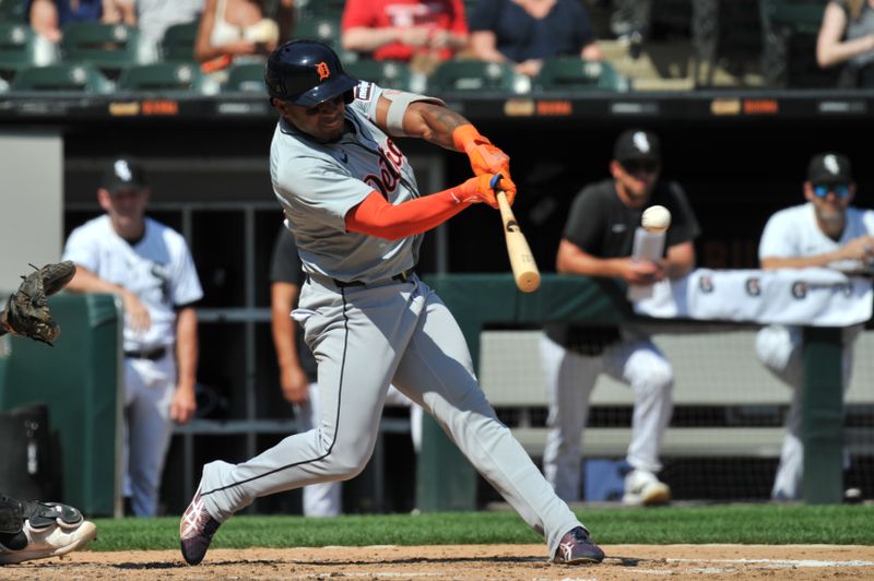 Aug 25, 2024; Chicago, Illinois, USA; Detroit Tigers second base Andy Ibanez (77) hits a sacrifice ground ball RBI during the fifth inning against the Chicago White Sox at Guaranteed Rate Field. Mandatory Credit: Patrick Gorski-USA TODAY Sports
