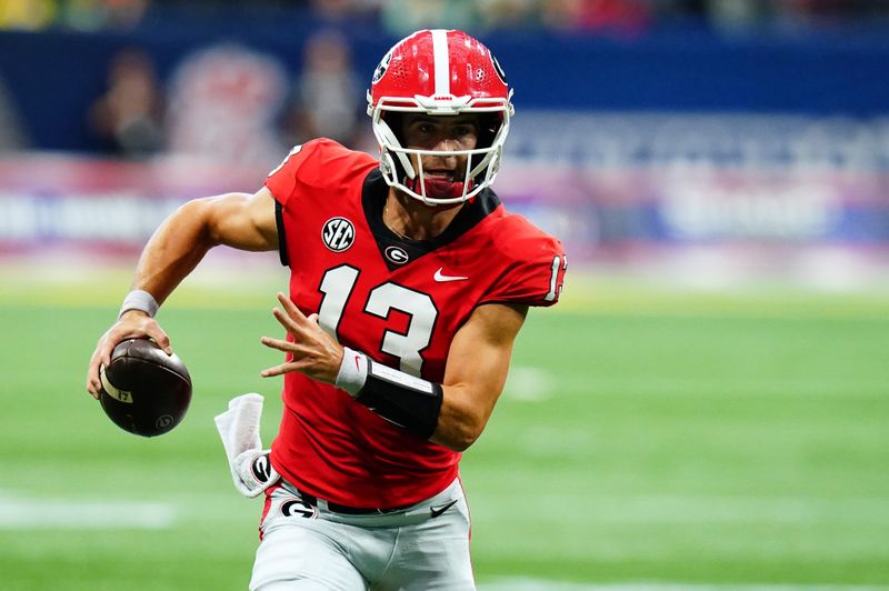 Sep 3, 2022; Atlanta, Georgia, USA; Georgia Bulldogs quarterback Stetson Bennett (13) scrambles out under the Oregon Ducks defense during the first quarter of the Chick-fil-A kickoff game at Mercedes-Benz Stadium. Mandatory Credit: John David Mercer-USA TODAY Sports