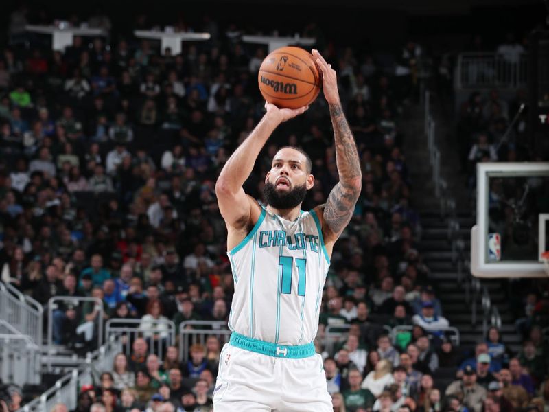 MILWAUKEE, WI - NOVEMBER 23:  Cody Martin #11 of the Charlotte Hornets shoots a three point basket during the game against the Milwaukee Bucks on November 23, 2024 at the Fiserv Forum Center in Milwaukee, Wisconsin. NOTE TO USER: User expressly acknowledges and agrees that, by downloading and or using this Photograph, user is consenting to the terms and conditions of the Getty Images License Agreement. Mandatory Copyright Notice: Copyright 2023 NBAE (Photo by Gary Dineen/NBAE via Getty Images).