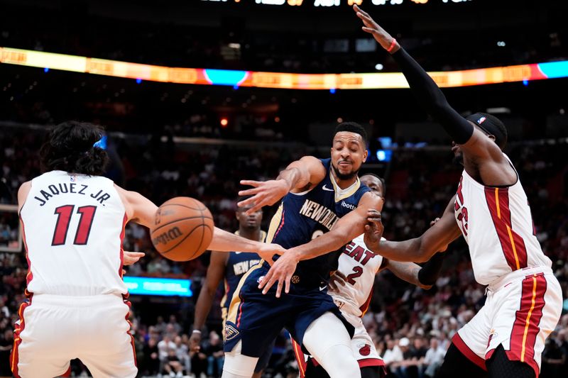 MIAMI, FLORIDA - MARCH 22: CJ McCollum #3 of the New Orleans Pelicans throws a pass against Jaime Jaquez Jr. #11 of the Miami Heat during the third quarter at Kaseya Center on March 22, 2024 in Miami, Florida. NOTE TO USER: User expressly acknowledges and agrees that, by downloading and or using this photograph, User is consenting to the terms and conditions of the Getty Images License Agreement. (Photo by Rich Storry/Getty Images)