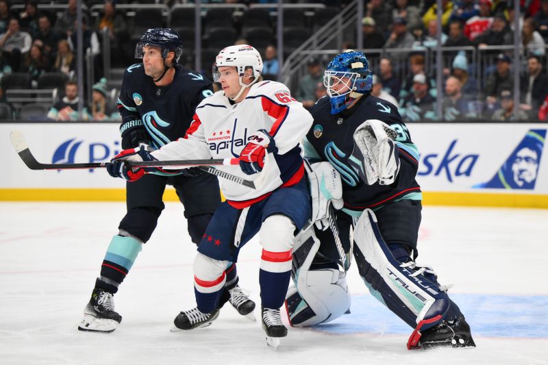 Mar 14, 2024; Seattle, Washington, USA; Seattle Kraken defenseman Brian Dumoulin (8) and Washington Capitals left wing Ivan Miroshnichenko (63) and Seattle Kraken goaltender Joey Daccord (35) during the first period at Climate Pledge Arena. Mandatory Credit: Steven Bisig-USA TODAY Sports