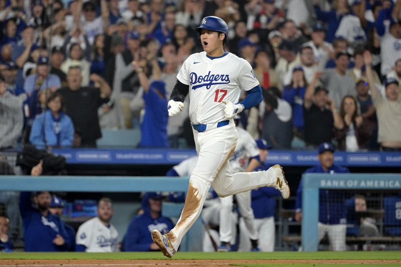 Sep 26, 2024; Los Angeles, California, USA;Los Angeles Dodgers designated hitter Shohei Ohtani (17) scores on a RBI single by shortstop Mookie Betts (50) in the seventh inning against the San Diego Padres at Dodger Stadium. Mandatory Credit: Jayne Kamin-Oncea-Imagn Images