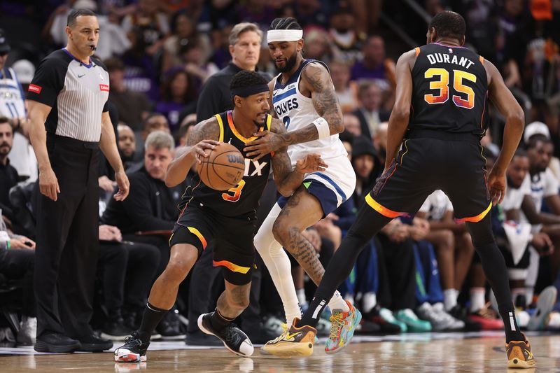 PHOENIX, ARIZONA - APRIL 28: Bradley Beal #3 of the Phoenix Suns handles the ball against Nickeil Alexander-Walker #9 of the Minnesota Timberwolves during the first half of game four of the Western Conference First Round Playoffs at Footprint Center on April 28, 2024 in Phoenix, Arizona. NOTE TO USER: User expressly acknowledges and agrees that, by downloading and or using this photograph, User is consenting to the terms and conditions of the Getty Images License Agreement.  (Photo by Christian Petersen/Getty Images)