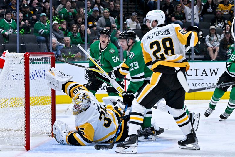 Mar 22, 2024; Dallas, Texas, USA; Pittsburgh Penguins goaltender Tristan Jarry (35) makes a blocker save as defenseman Marcus Pettersson (28) and Dallas Stars center Roope Hintz (24) and defenseman Esa Lindell (23) look for the rebound during the second period at the American Airlines Center. Mandatory Credit: Jerome Miron-USA TODAY Sports