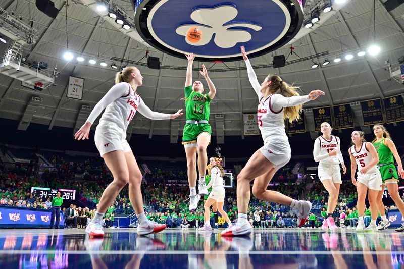 Feb 29, 2024; South Bend, Indiana, USA; Notre Dame Fighting Irish guard Anna Dewolfe (13) goes up for a shot between Virginia Tech Hokies guard Matilda Ekh (11) and Virginia Tech Hokies center Elizabeth Kitley (33) in the first half at the Purcell Pavilion. Mandatory Credit: Matt Cashore-USA TODAY Sports