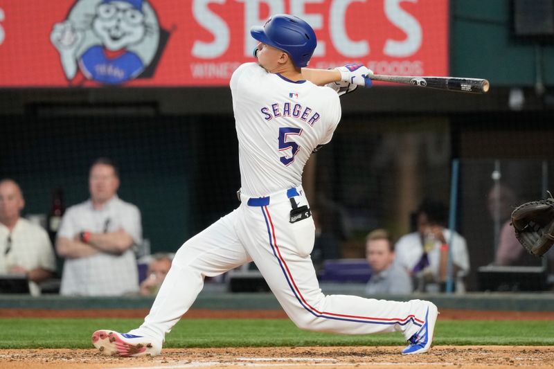 May 29, 2024; Arlington, Texas, USA;  Texas Rangers shortstop Corey Seager (5) follows through on his two-run home run against the Arizona Diamondbacks during the fifth inning at Globe Life Field. Mandatory Credit: Jim Cowsert-USA TODAY Sports