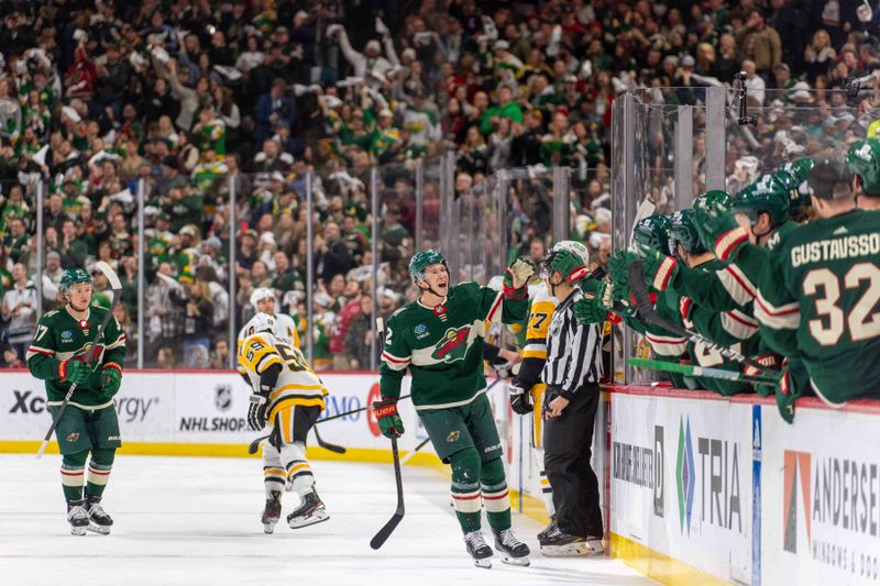 Feb 9, 2024; Saint Paul, Minnesota, USA; Minnesota Wild left wing Matt Boldy (12) celebrates a goal with with the Minnesota Wild bench after scoring on the Pittsburgh Penguins in the first period at Xcel Energy Center. Mandatory Credit: Matt Blewett-USA TODAY Sports