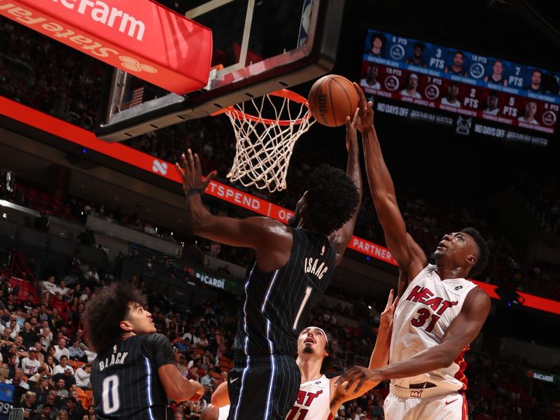 MIAMI, FL - OCTOBER 23: Jonathan Isaac #1 of the Orlando Magic drives to the basket while Thomas Bryant #31 of the Miami Heat goes up for the block on October 23, 2024 at Kaseya Center in Miami, Florida. NOTE TO USER: User expressly acknowledges and agrees that, by downloading and or using this Photograph, user is consenting to the terms and conditions of the Getty Images License Agreement. Mandatory Copyright Notice: Copyright 2024 NBAE (Photo by Issac Baldizon/NBAE via Getty Images)