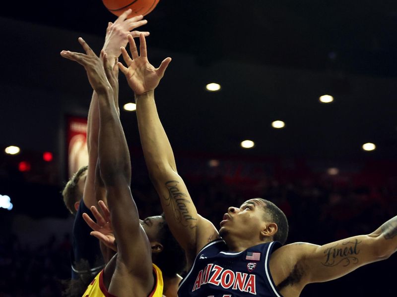 Jan 17, 2024; Tucson, Arizona, USA; Arizona Wildcats forward Keshad Johnson (16) jumps for a rebound against USC Trojans guard Boogie Ellis (5) during the first half at McKale Center. Mandatory Credit: Zachary BonDurant-USA TODAY Sports