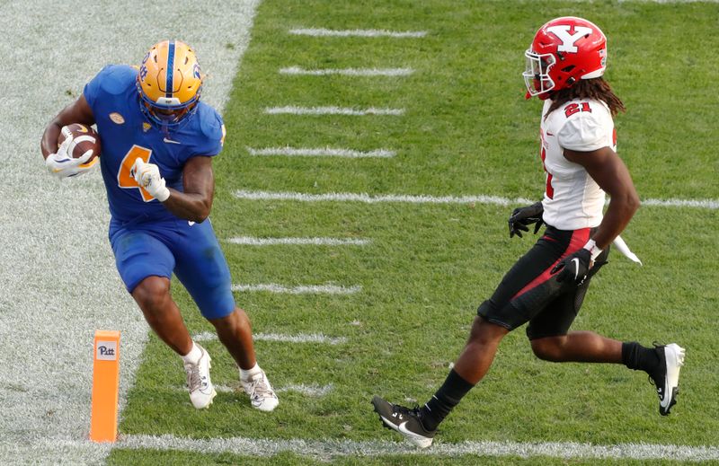 Sep 21, 2024; Pittsburgh, Pennsylvania, USA;  Pittsburgh Panthers running back Daniel Carter (4) steps into the end-zone to score a touchdown against Youngstown State Penguins defensive back DJ Harris (21) during the fourth quarter at Acrisure Stadium. Mandatory Credit: Charles LeClaire-Imagn Images