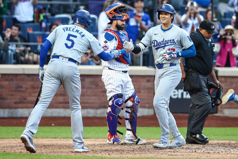 May 29, 2024; New York City, New York, USA;  Los Angeles Dodgers designated hitter Shohei Ohtani (17) is greeted by first baseman Freddie Freeman (5) after hitting a two run home run in the eighth inning against the New York Mets at Citi Field. Mandatory Credit: Wendell Cruz-USA TODAY Sports