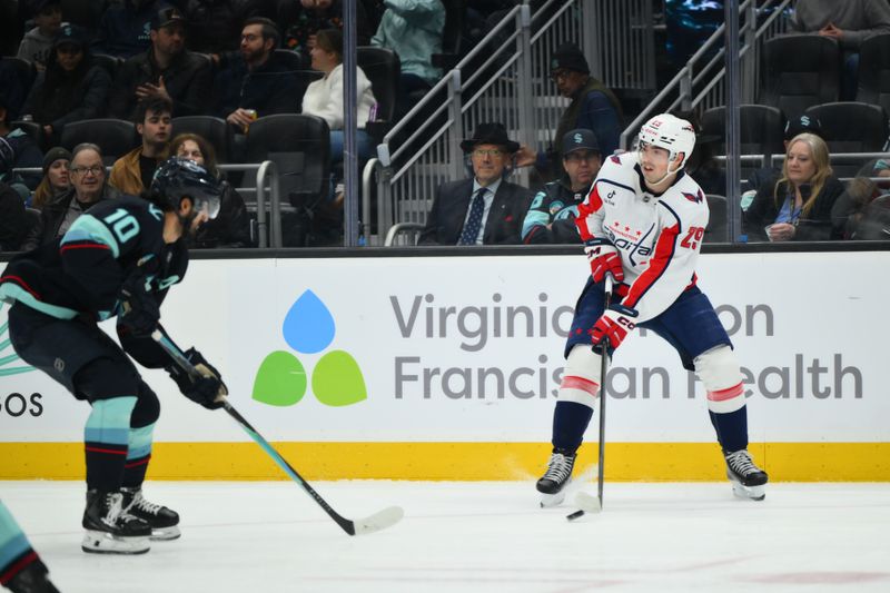 Jan 27, 2026; Seattle, Washington, USA; Washington Capitals center Hendrix Lapierre (29) passes the puck against the Seattle Kraken during the first period at Climate Pledge Arena. Mandatory Credit: Steven Bisig-Imagn Images
