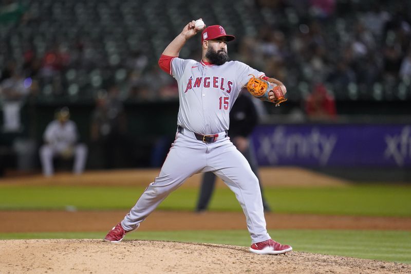 Jul 19, 2024; Oakland, California, USA; Los Angeles Angels pitcher Luis Guillorme (15) delivers a pitch against the Oakland Athletics in the eighth inning at Oakland-Alameda County Coliseum. Mandatory Credit: Cary Edmondson-USA TODAY Sports