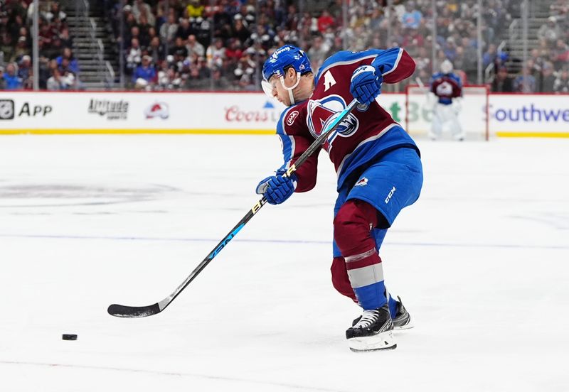 Oct 18, 2024; Denver, Colorado, USA; Colorado Avalanche center Nathan MacKinnon (29) shoots the puck in the second period against the Anaheim Ducks at Ball Arena. Mandatory Credit: Ron Chenoy-Imagn Images