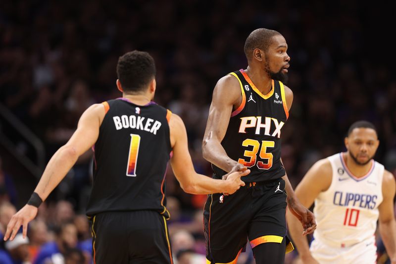 PHOENIX, ARIZONA - APRIL 18: Kevin Durant #35 of the Phoenix Suns high fives Devin Booker #1 after scoring against the LA Clippers during the first half of Game Two of the Western Conference First Round Playoffs at Footprint Center on April 18, 2023 in Phoenix, Arizona. (Photo by Christian Petersen/Getty Images)