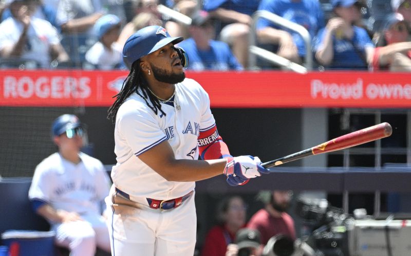 Jun 6, 2024; Toronto, Ontario, CAN;  Toronto Blue Jays first baseman Vladimir Guerrero Jr. (27) hits a three run home run against the Baltimore Orioles in the third inning at Rogers Centre. Mandatory Credit: Dan Hamilton-USA TODAY Sports