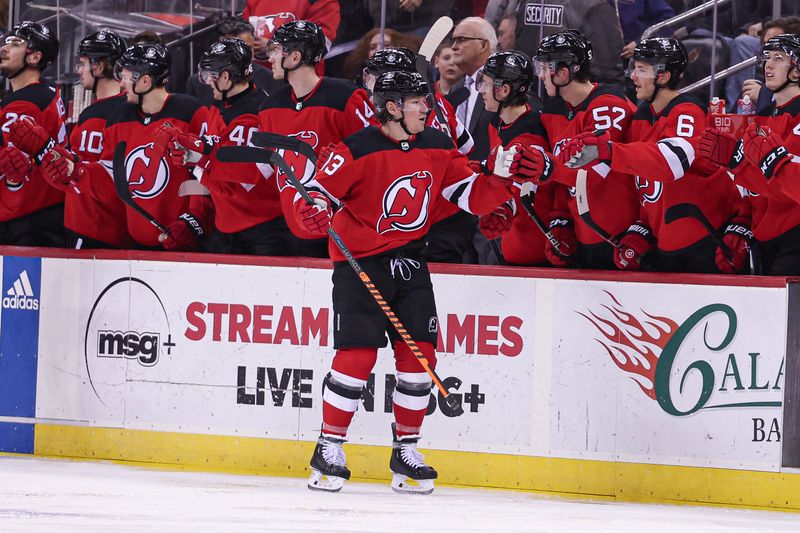 Jan 22, 2024; Newark, New Jersey, USA; New Jersey Devils center Nico Hischier (13) celebrates his goal with teammates during the second period against the Vegas Golden Knights at Prudential Center. Mandatory Credit: Vincent Carchietta-USA TODAY Sports